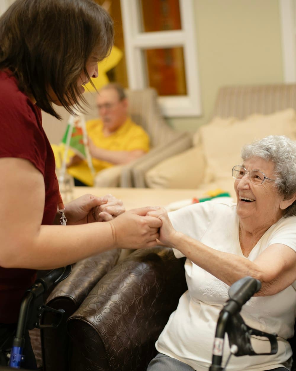 A nurse care manager sharing a warm moment with an older client